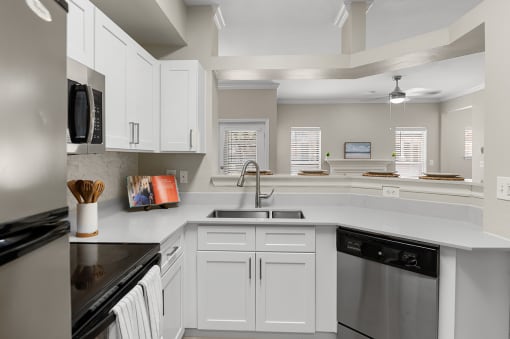 Kitchen with white shaker-style cabinets and stainless steel appliances