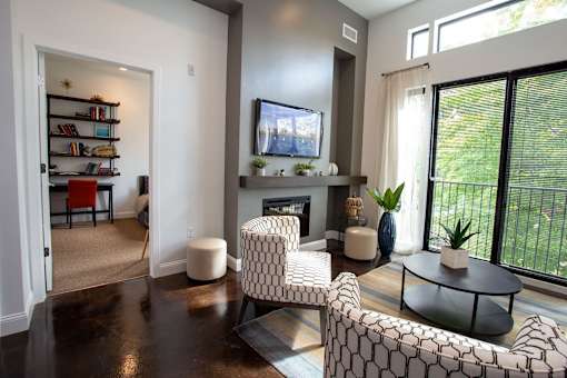 A living room with a fireplace and a television.
