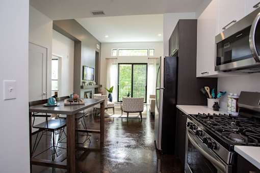 A kitchen with a stove top oven and a refrigerator.