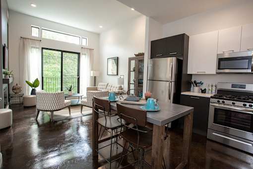 A modern kitchen with a dining table and chairs.