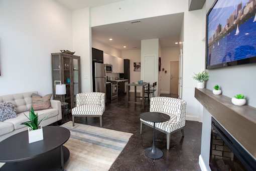 A living room with a couch, two chairs, and a coffee table.