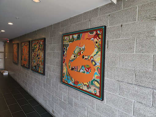 Colorful artwork display on hallway wall at 68 Beale Apartments, Quincy, Massachusetts
