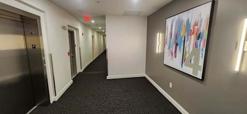 Fourth floor hallway with modern lighting fixtures at 68 Beale Apartments, Massachusetts