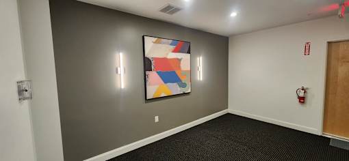 Interior corridor with contemporary art and dark carpet at 68 Beale Apartments, Massachusetts, 02169