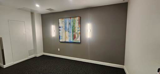 Modern room with abstract painting and wall lighting at 68 Beale Apartments, Quincy, MA 02169