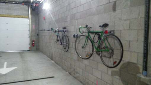 Indoor bicycle storage area with wall mounted racks at 68 Beale Apartments, Quincy, MA