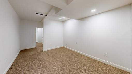 A room with carpeted floor and white walls.