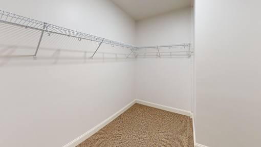 A white wall with a metal rack on it.