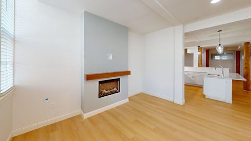 A room with a fireplace and a white cabinet.