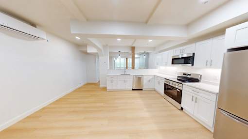 A kitchen with white cabinets and stainless steel appliances.