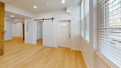 A room with a wooden floor and white walls.