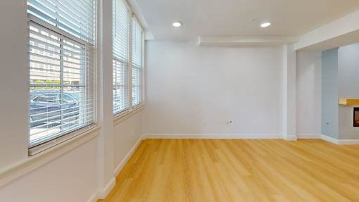 A room with wooden floors and white walls.