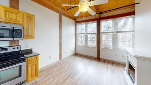 A kitchen with wooden cabinets and a black stove top oven.