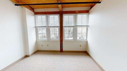 A room with a window and a door.