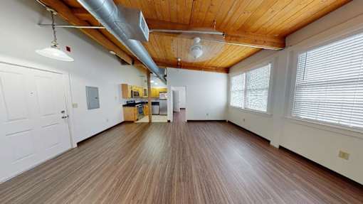 A room with wooden floors and a white door.