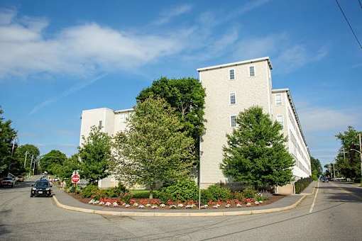 A large white building with a red stop sign in front of it.