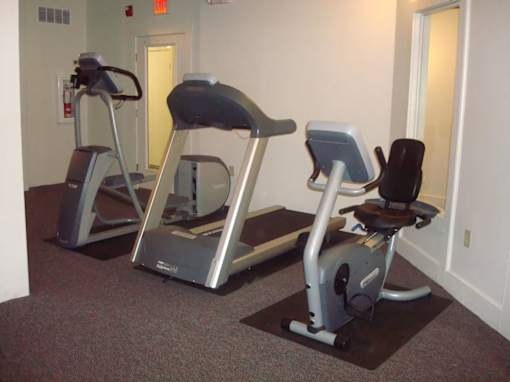 Two exercise bikes are in a room.