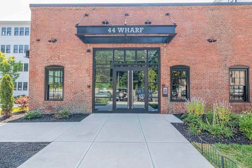 The front of a building with the name 44 Wharf on it.