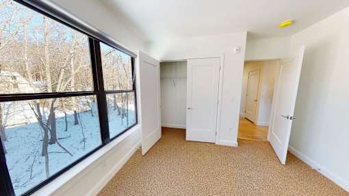 A room with a large window showing a snowy landscape outside.