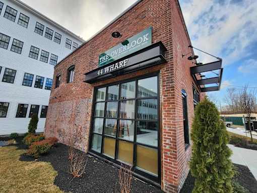 The Overlook 44 Wharf is a modern building with a brick facade and large glass windows.
