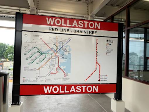Wollaston station sign with red line transit map at 68 Beale Apartments, Quincy