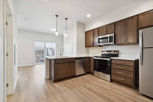 A modern kitchen with wooden cabinets and stainless steel appliances.