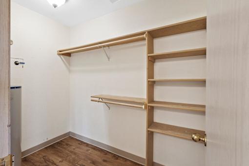 A white room with a shelving unit and a door.