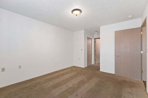 A room with a carpeted floor and a ceiling light.