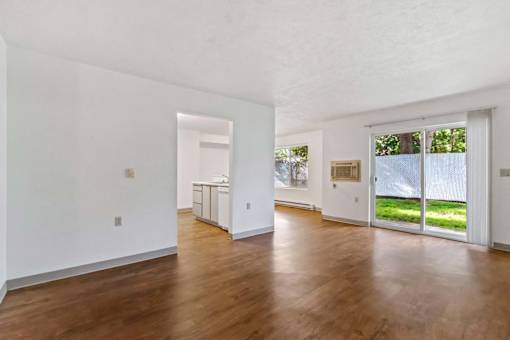 A room with wooden floors and white walls.