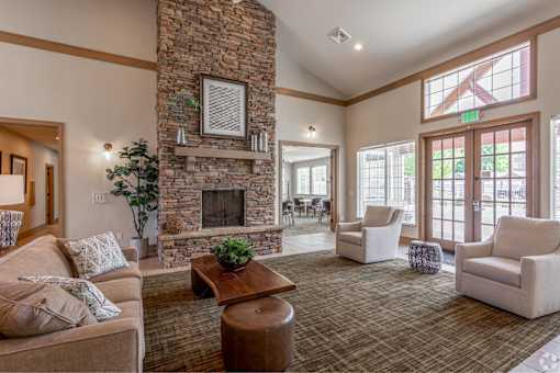 A living room with a stone fireplace and a couch.