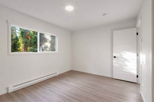 A room with a window and a door.