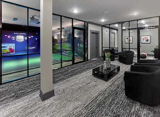 A room with a Full Swing golf simulator on the wall.