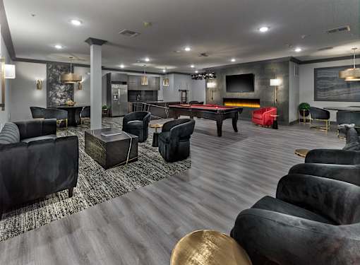 A modern living room with a pool table and a fireplace.