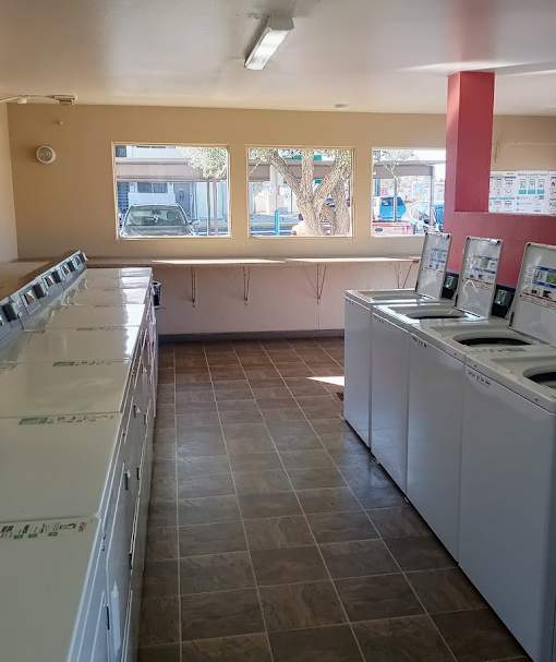 A laundromat with rows of washers and dryers.