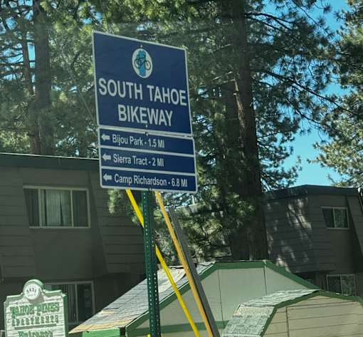 A sign for the South Tahoe Bikeway is shown in front of a building.