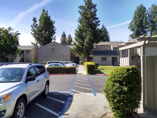Colonial Farms Apartments - view of parking lot with apartment buildings in the background