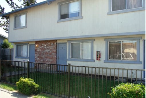 a house with a fence in front of it