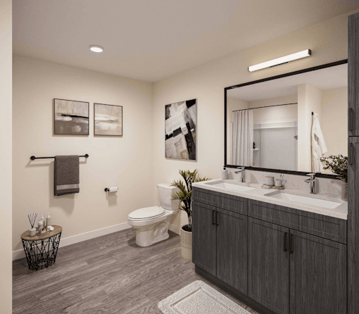 A bathroom with a toilet, sink, and mirror.