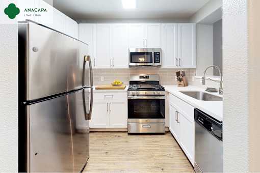 A modern kitchen with stainless steel appliances and white cabinets at Mission Hills, Camarillo, 93012