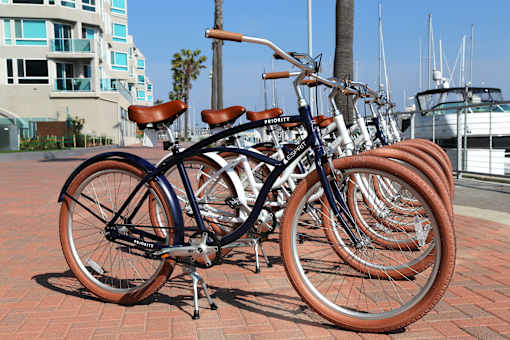 A bicycle with a brown seat is parked among other bicycles at Esprit Marina del Rey, 90292