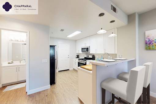 A well-lit kitchen with a dining table and chairs at Mission Hills, Camarillo, 93012