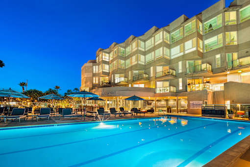 A large pool in front of a building with a sign that says at Esprit Marina del Rey, 90292
