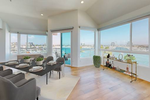 A dining room with a table set for six with a view of the city at Esprit Marina del Rey, 90292