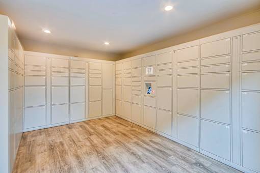 a large walk in closet with white cabinets and a wood floor at Villa Vicente, Los Angeles, CA