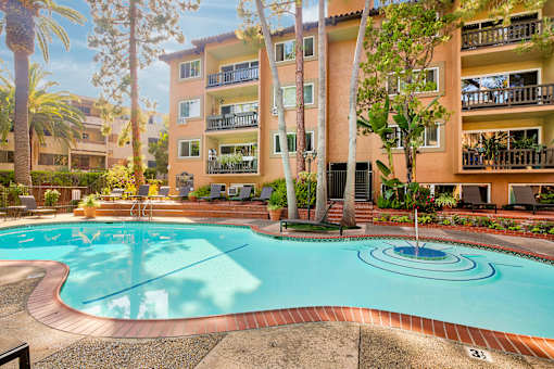 a swimming pool with an apartment building in the background at Casa Granada, Los Angeles, CA, 90049