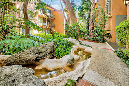 a small waterfall in the middle of a courtyard  at Casa Granada, Los Angeles, CA