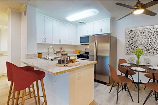 a kitchen with a breakfast bar and a stainless steel refrigerator at Casa Granada, Los Angeles, 90049