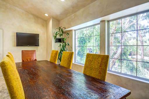 a dining room with a large window and a wooden table