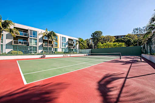 a tennis court with apartments in the background  at Marina Harbor, California, 90292