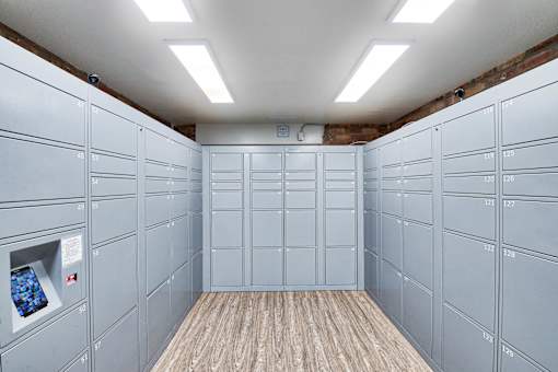 a bunch of white lockers in a room with a wood floor at The Meadows Apartments, Culver City , CA 90230